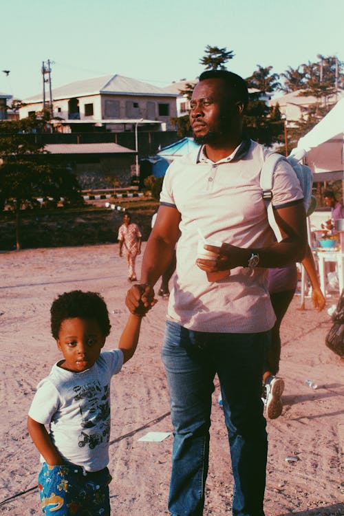 Free Man Holding hand with His Son Stock Photo