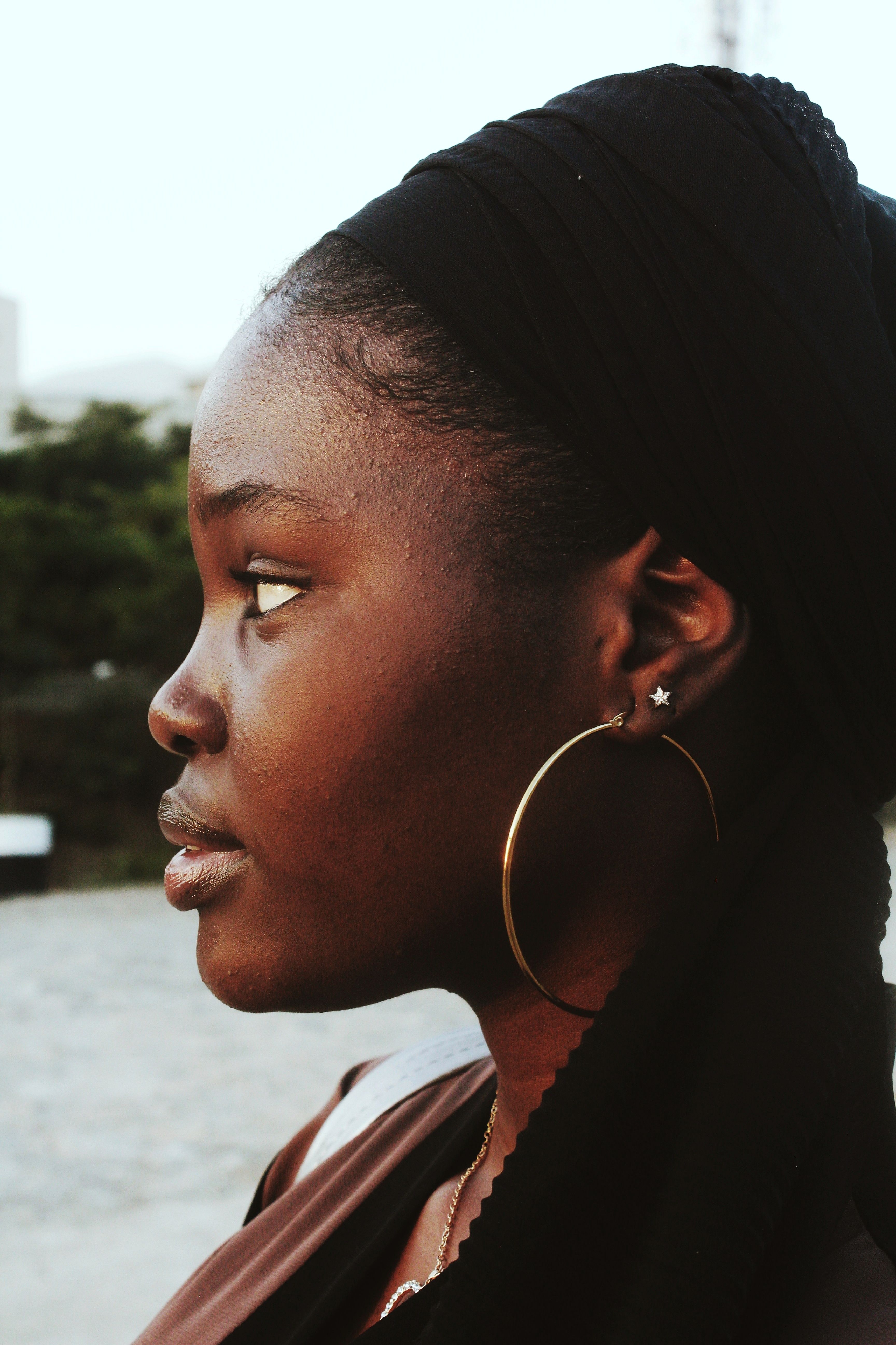 Profile of a Woman Wearing Hoop Earrings · Free Stock Photo