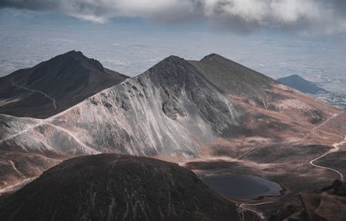 A Brown and Gray Mountain Under Gray Clouds