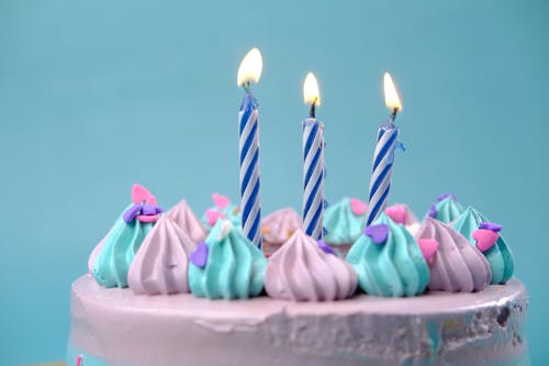 Free Pink and Blue Candles on White Cake Stock Photo