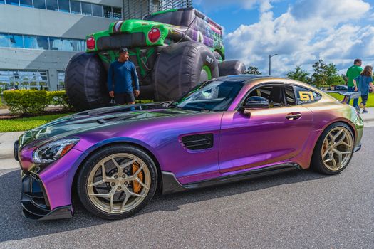 Purple Porsche 911 Parked in Front of Man in Black Jacket