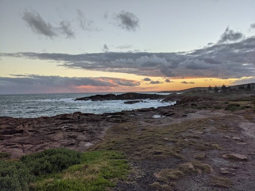 Sea Waves Crashing on Shore during Sunset