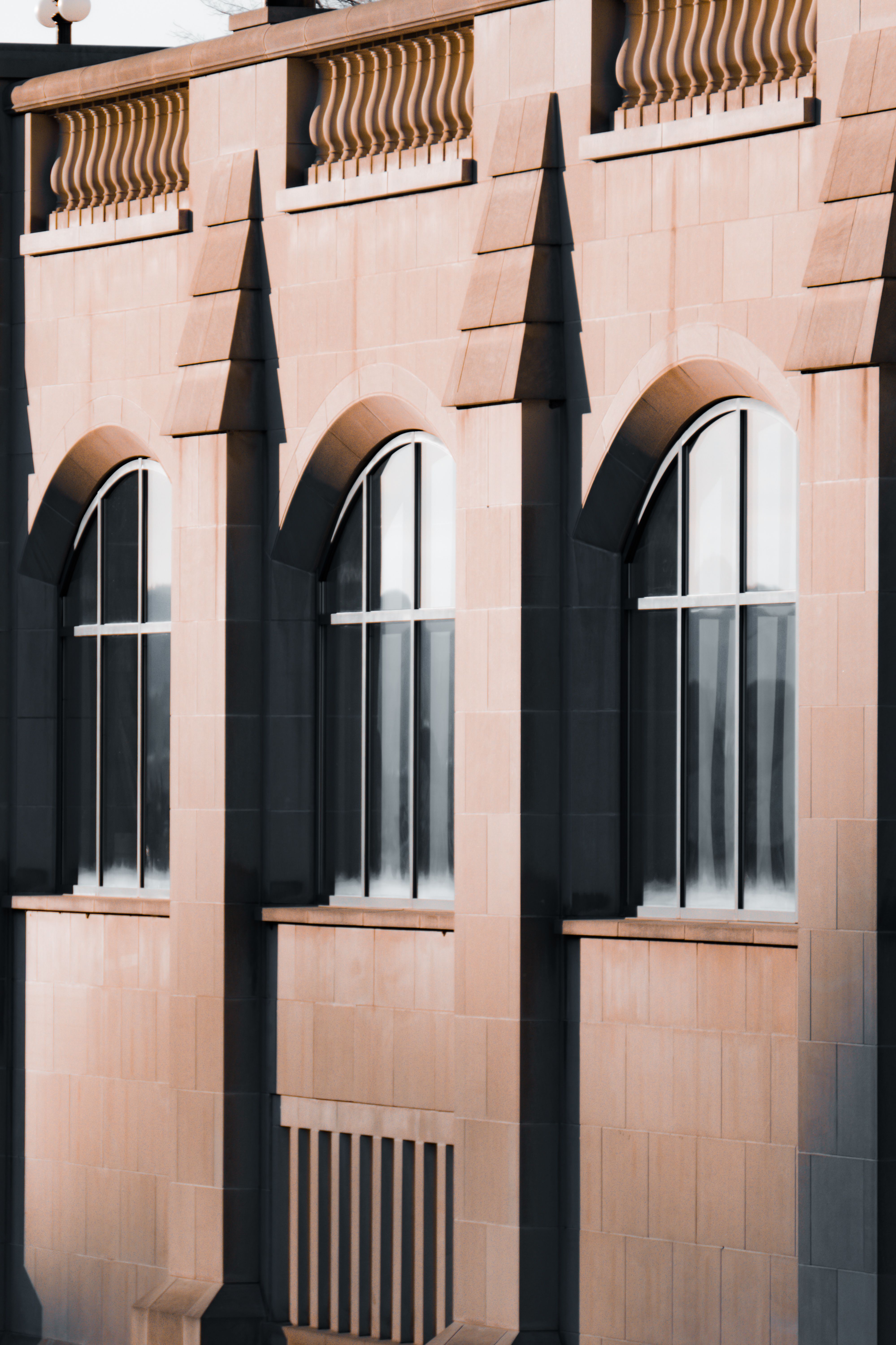 Majestic Gothic revival building facade with arched windows and detailed stonework.