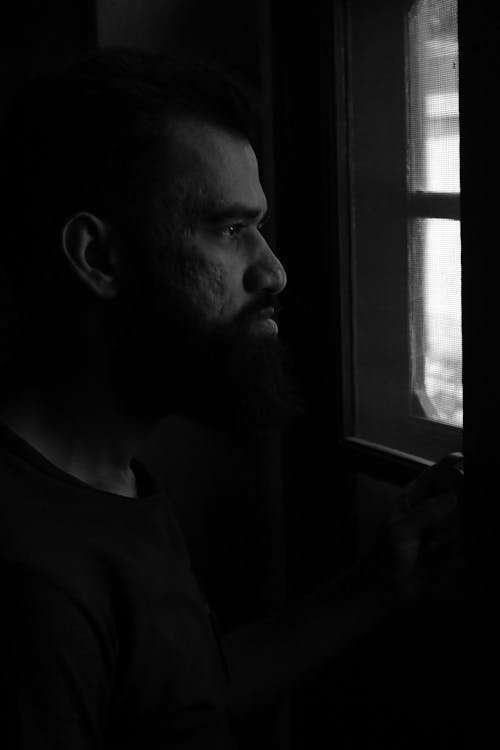 A Man Looking Out the Window