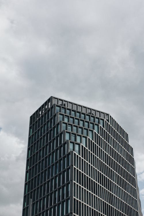 Free Gray Concrete Building Under Gray Clouds Stock Photo