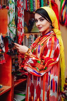 Woman in colorful traditional attire exploring a vibrant boutique. Captivating and stylish.