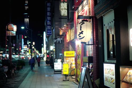 Free Vibrant nighttime street scene in Tokyo, featuring illuminated signs and bustling sidewalks. Stock Photo