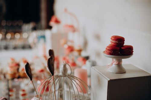 Free Red macarons elegantly displayed on a cake stand, perfect for dessert lovers. Stock Photo