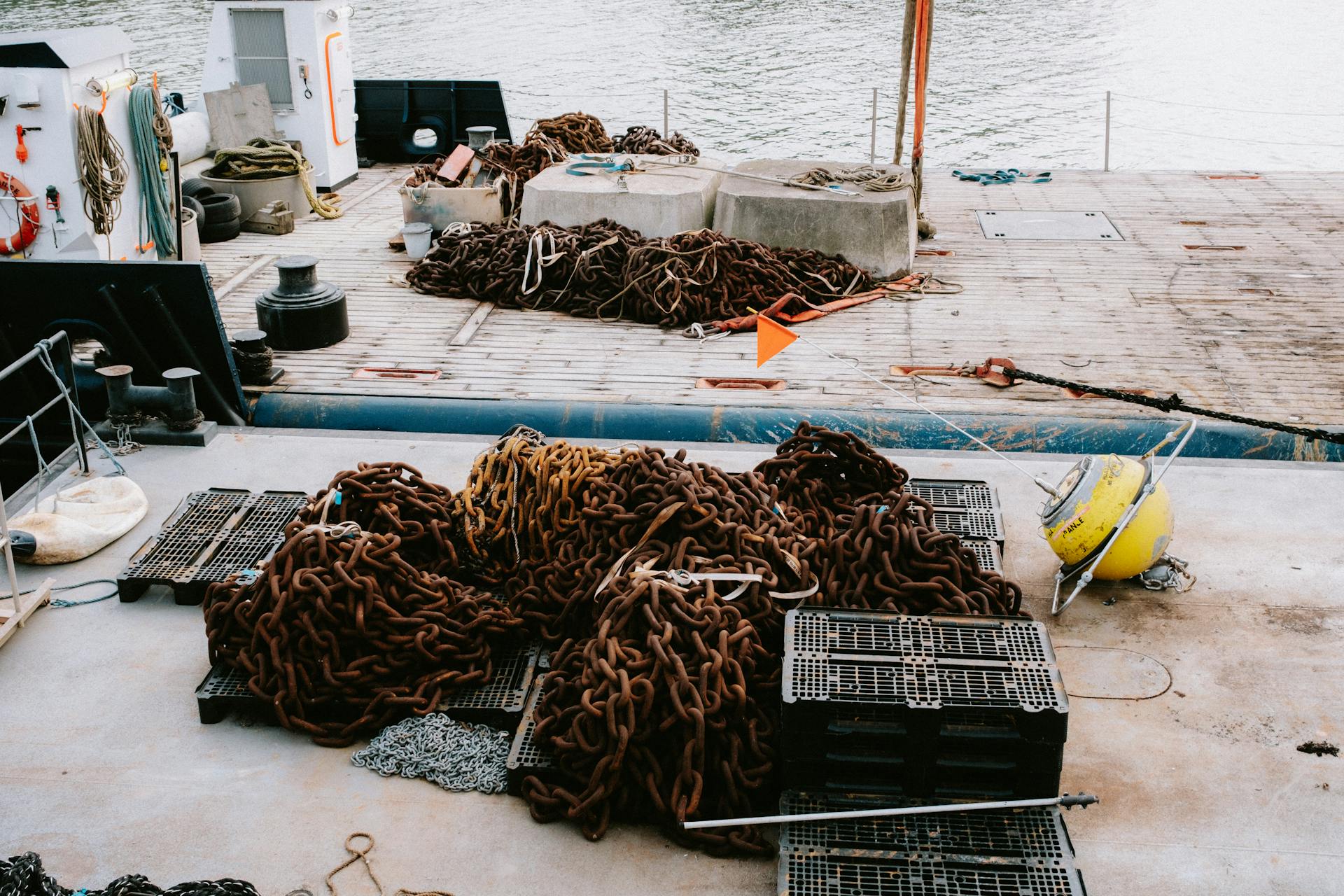 A detailed view of chains and equipment on a ship deck, perfect for maritime industry and travel themes.