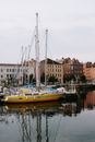 White and Yellow Boat on Water Near Brown Concrete Building