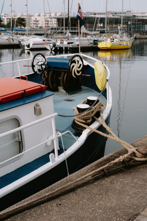 Free A vibrant and peaceful harbor view with colorful boats moored, reflecting calm waters. Stock Photo