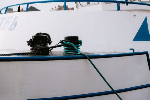 Free Detailed view of mooring ropes tied to posts on a docked yacht in a harbor. Stock Photo
