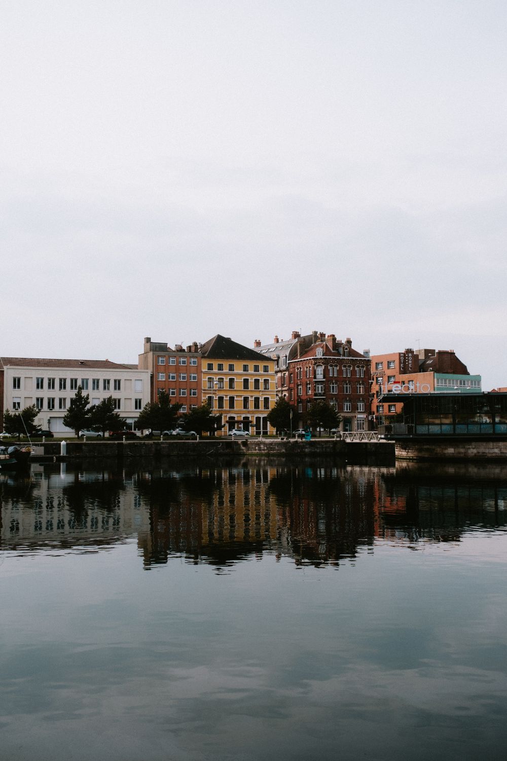 Cities Built On Rivers Group of City Buildings Built on Riverbank · Free Stock Photo