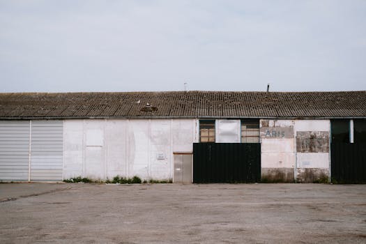 Rustic industrial warehouse with weathered facade and empty surroundings.