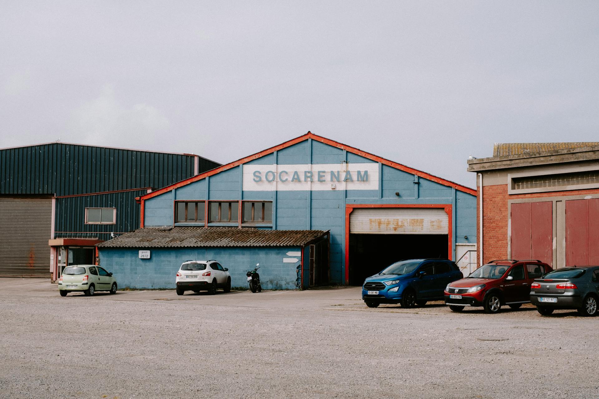 Cars Parked Beside a Warehouse