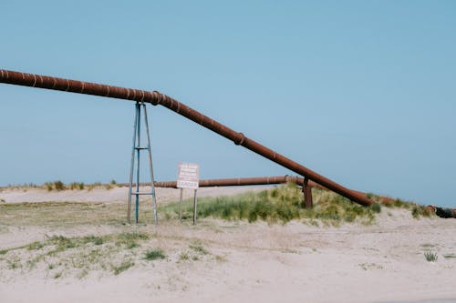 Industrial Pipe on Sand Beach