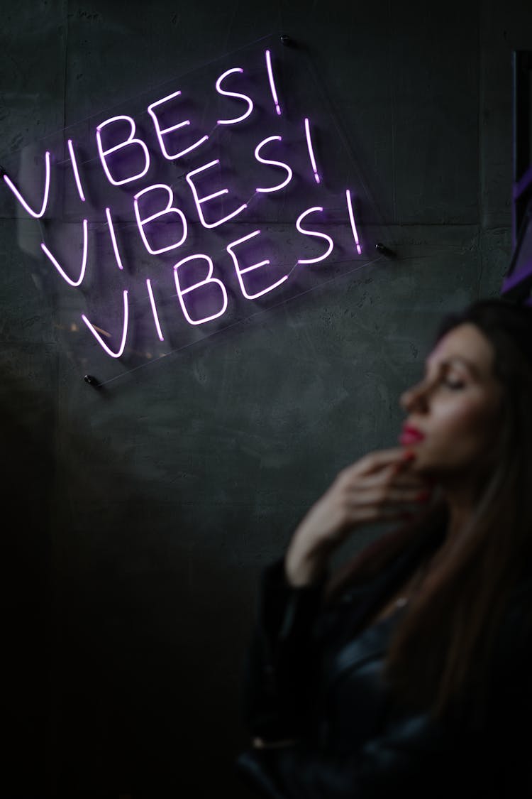 Woman Near Neon Light Sign On Wall