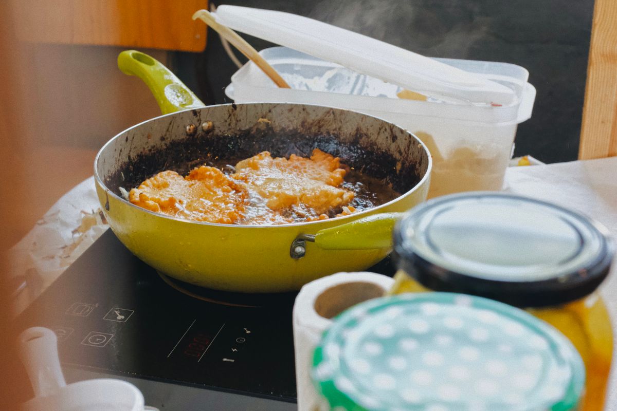 Alimento sendo preparado em frigideira sobre cooktop de indução