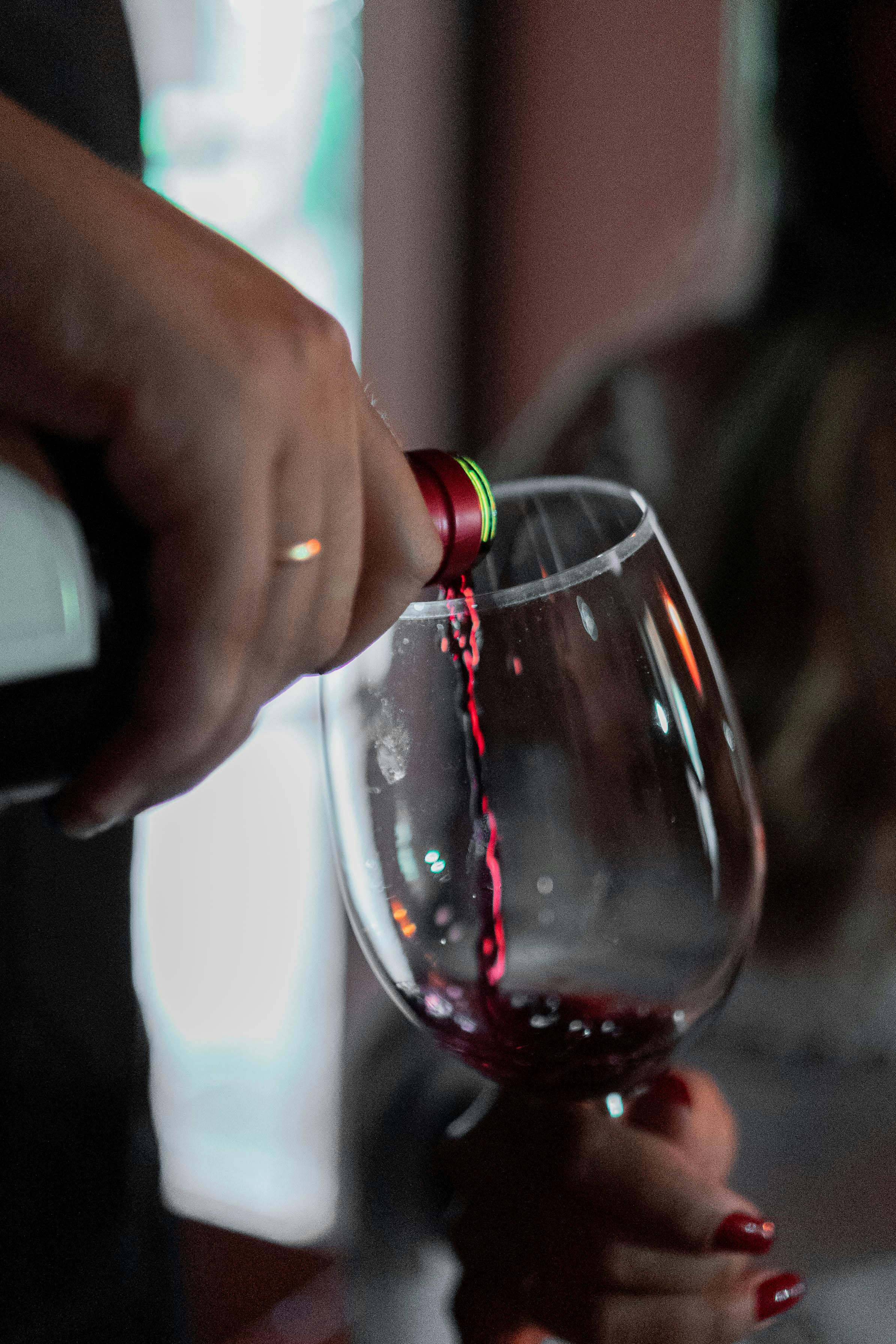 Person Pouring Red Wine on a Glass · Free Stock Photo