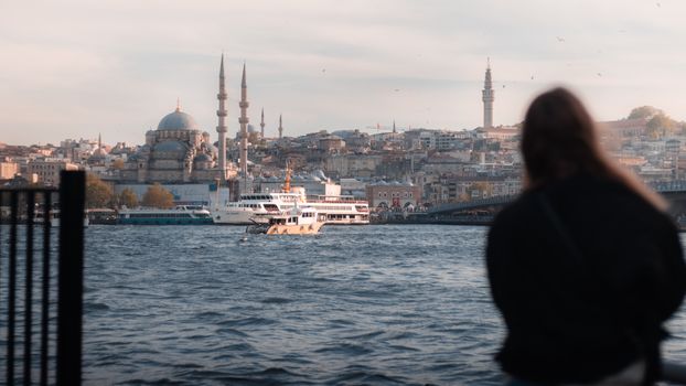 A ferry sails on the Bosphorus with the Istanbul skyline and mosque in view.