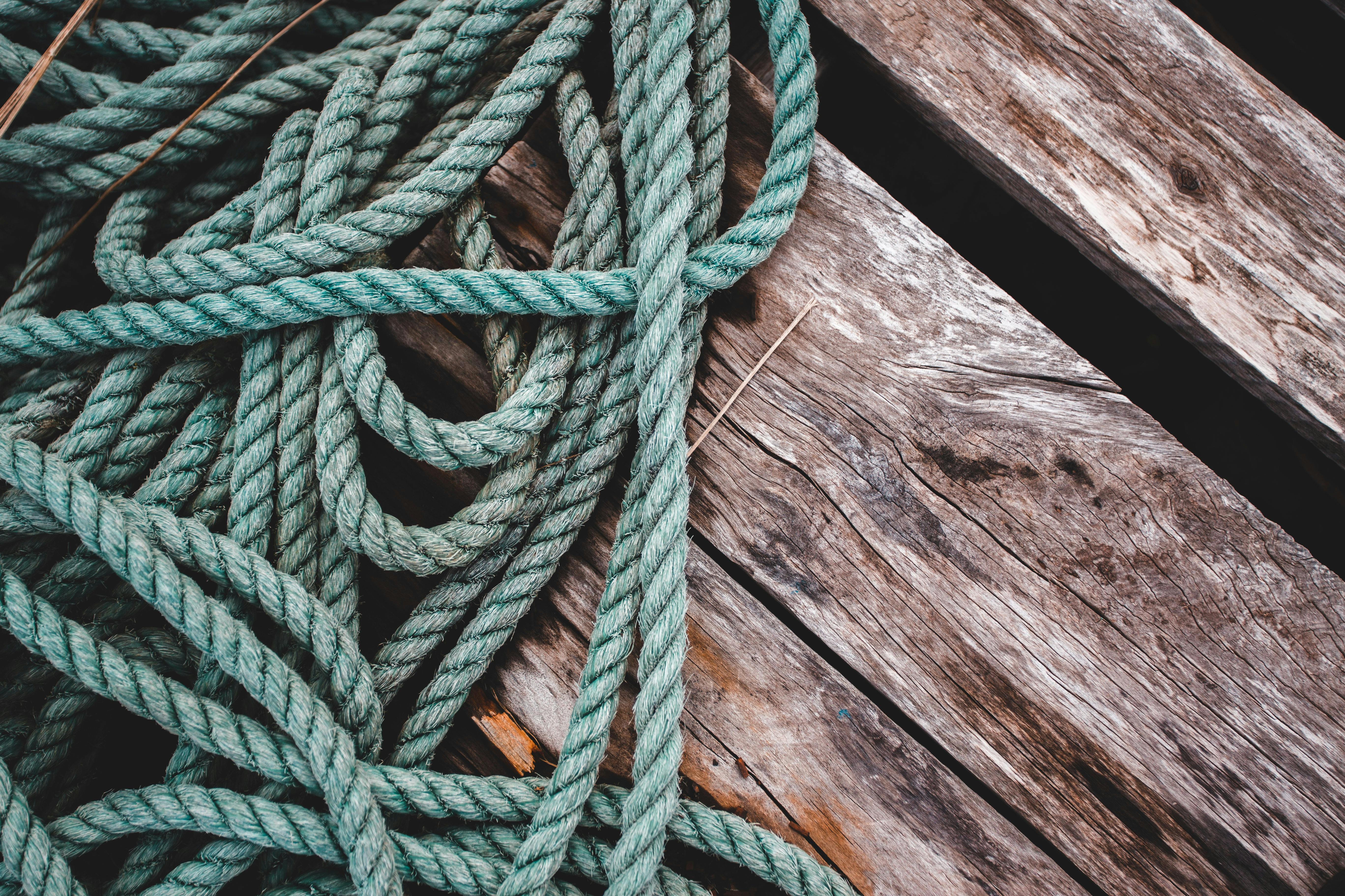 Close-Up Shot of a Rope on a Wooden Surface · Free Stock Photo