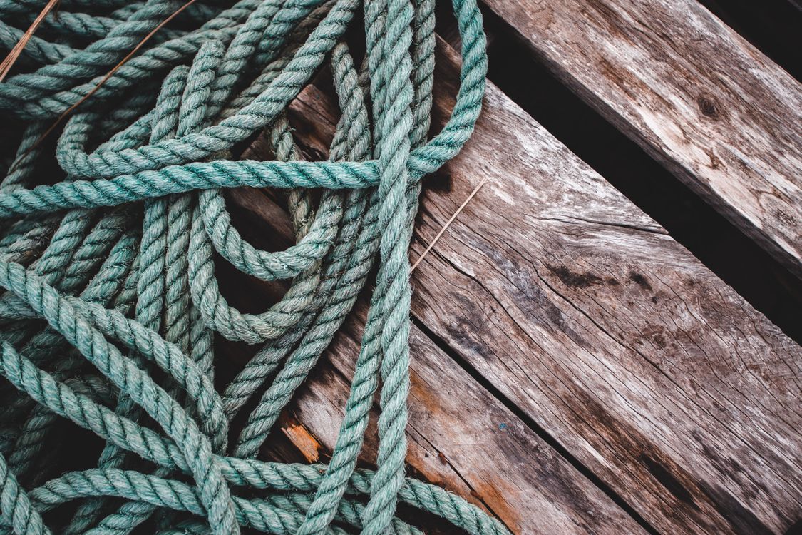 Close-Up Shot of a Rope on a Wooden Surface · Free Stock Photo