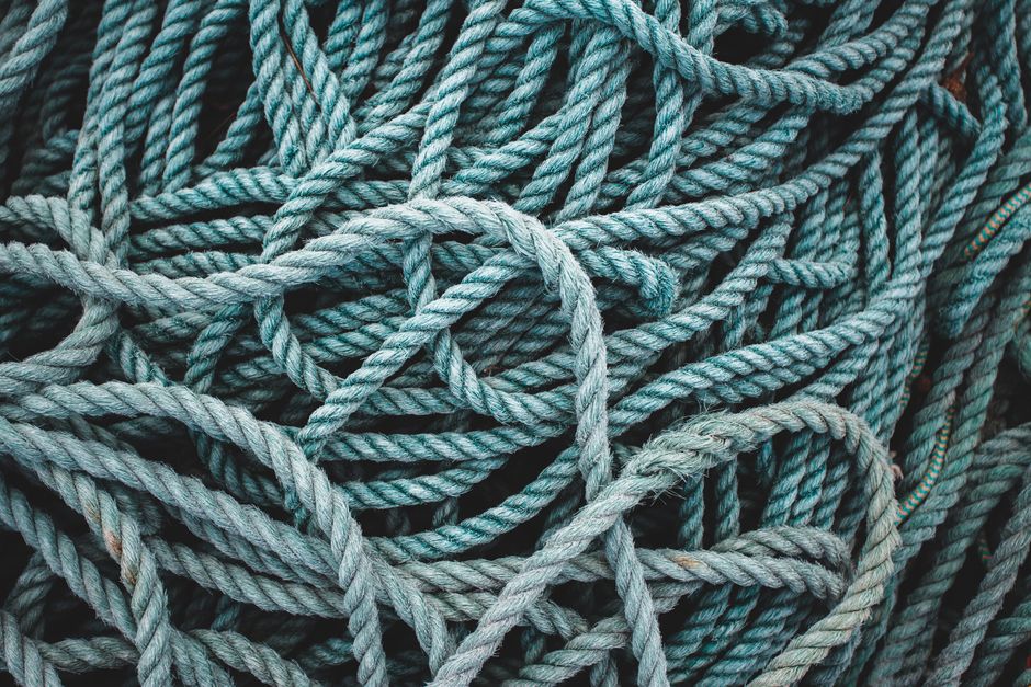 Intricate close-up of tangled blue ropes creating a textured pattern.