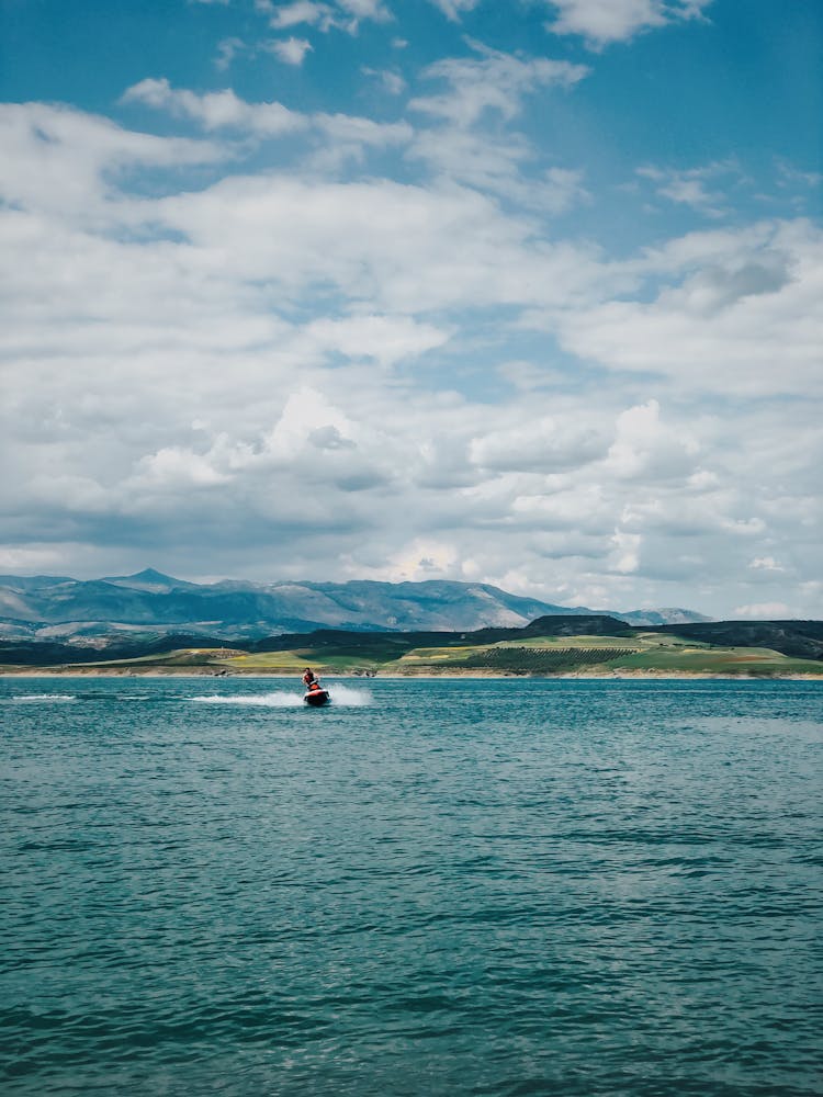 A Person Riding A Jetski On Sea