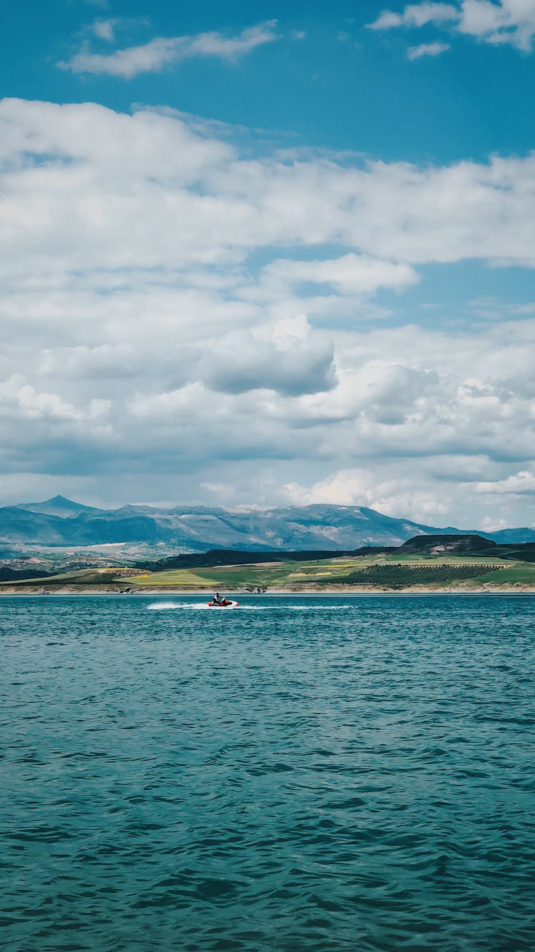 Person Riding A Jet Ski On The Lake