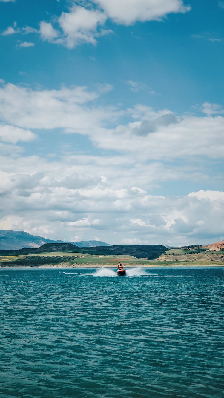 A Person Riding A Jetski On Sea