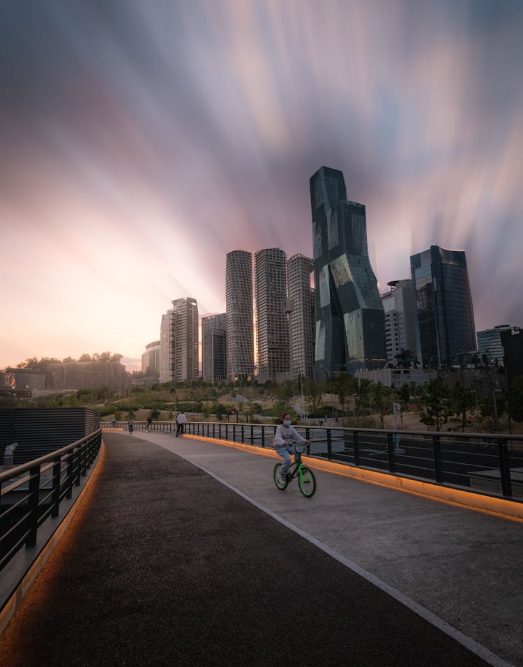 A Kid Riding Bicycle In The Park