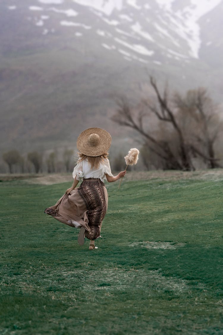 Woman Running On Meadow