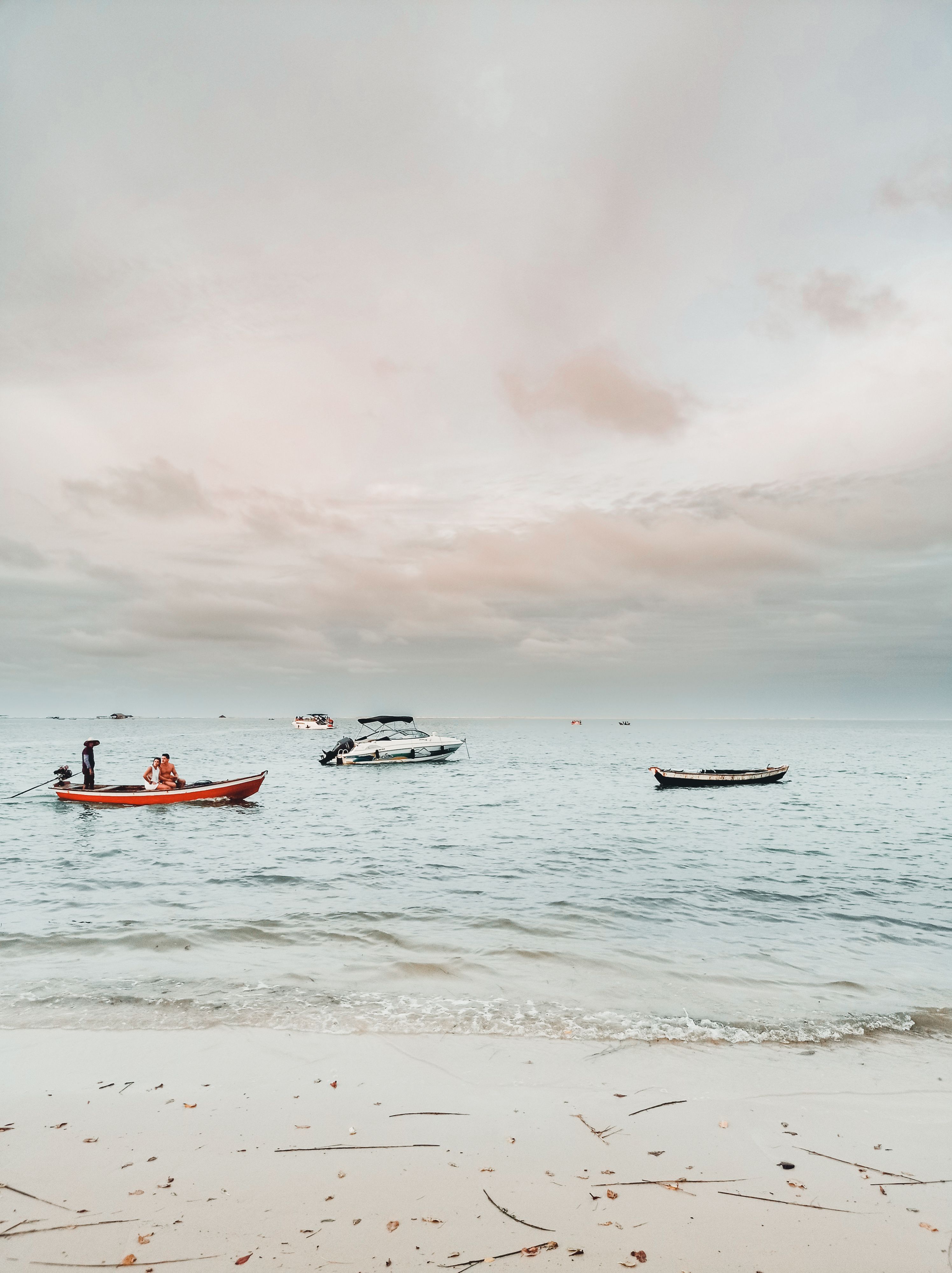 Serene beach scene with boats on the waters of Atins, Brazil, capturing a peaceful summer day.