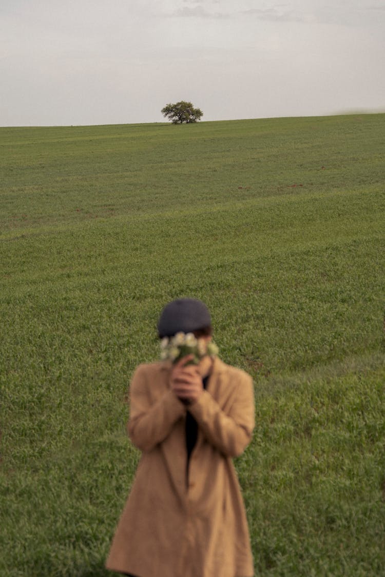 Man With Flowers Bouquet In Field