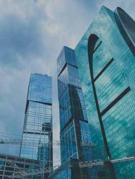 Low angle view of modern skyscrapers with glass facades in Moscow, Russia.
