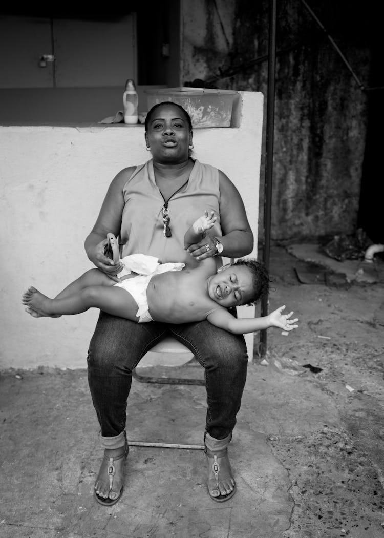 Grayscale Photo Of Woman With Baby On Her Lap