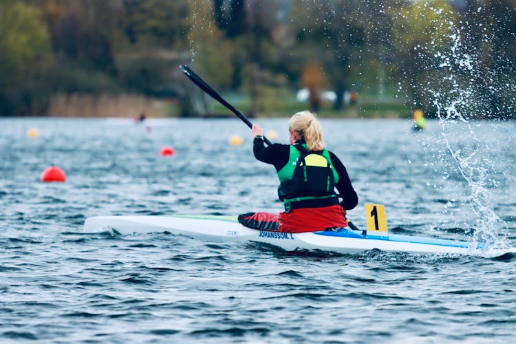 A Woman Kayaking On Lake