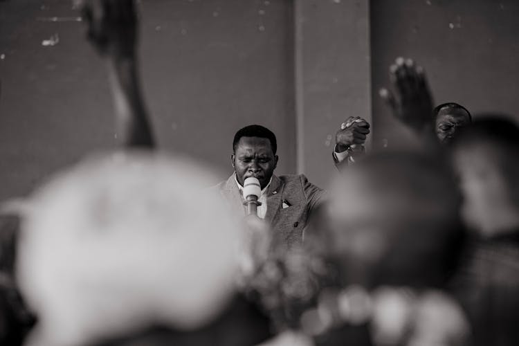 Grayscale Photo Of A Man Preaching