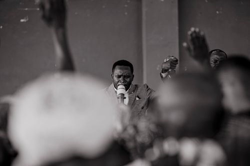 Free Black and white photograph capturing an emotional preacher speaking to a crowd. Stock Photo