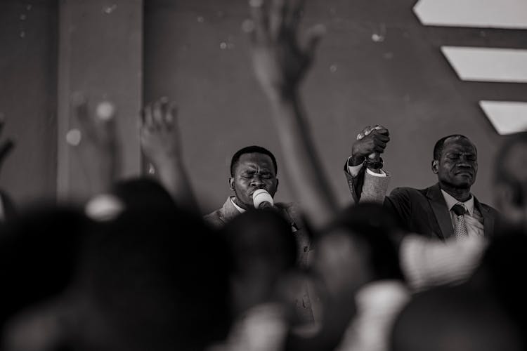 Grayscale Photo Of A Man Preaching