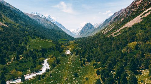 Free Explore the breathtaking aerial view of Chunkurchak Valley with lush greens and snow-capped mountains. Stock Photo