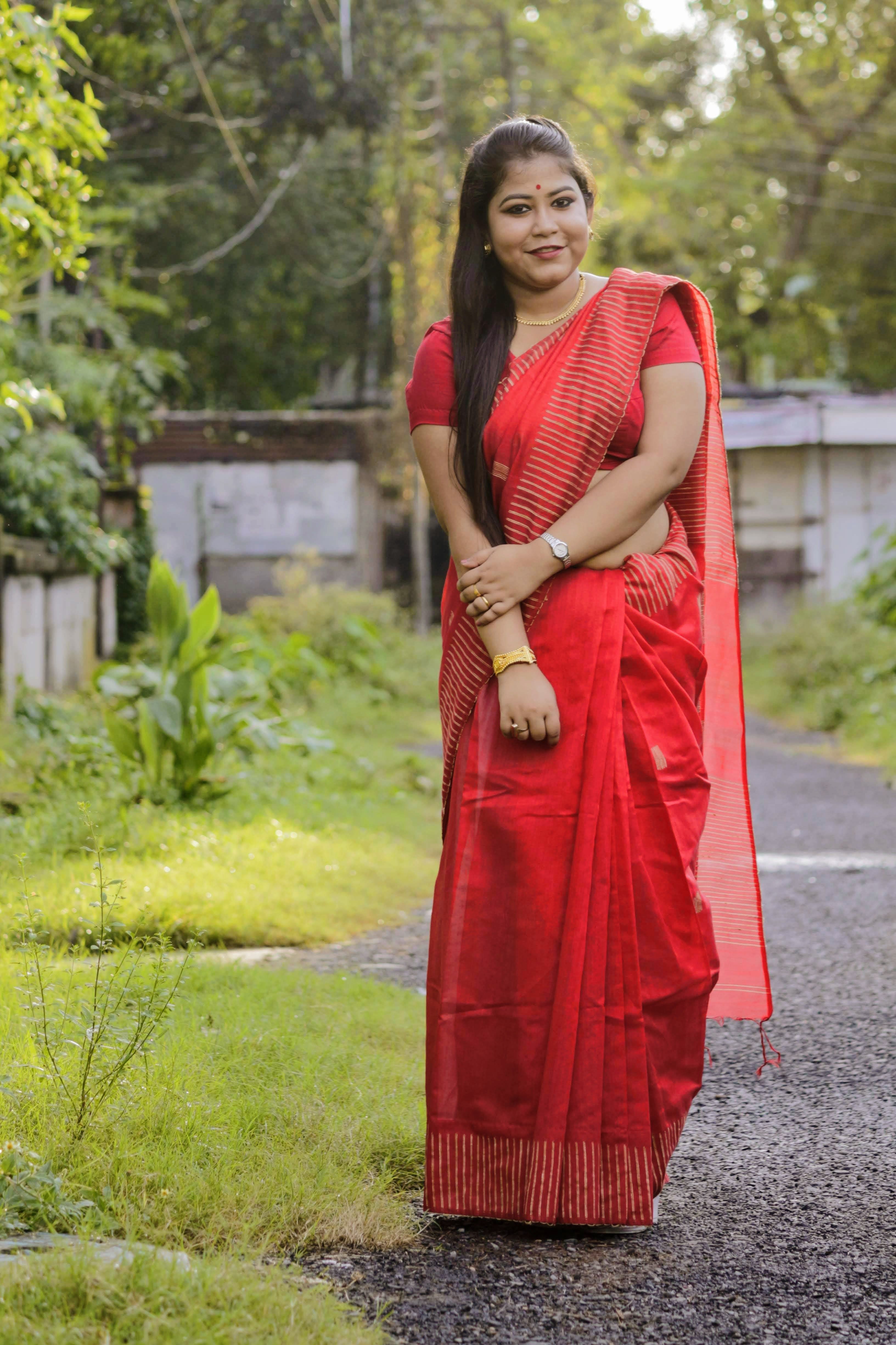 A Woman in Red Dress Standing on Asphalt · Free Stock Photo