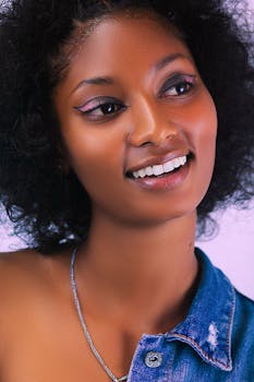 Vibrant portrait of a smiling woman with natural hair, conveying joy and confidence.