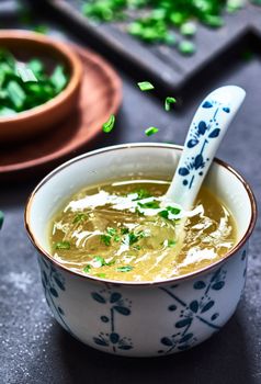 Warm, comforting homemade chicken soup garnished with fresh herbs in a ceramic bowl.