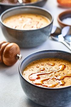 Close-up of Turkish red lentil soup drizzled with oil in ceramic bowls. Perfect for promoting Turkish cuisine.