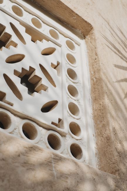Close-up of geometric window design showcasing traditional Arabic architecture in Dubai.