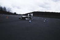 Red and Black F 1 Car on Gray Asphalt Road