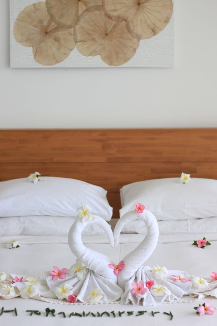 A Bed Decorated With Heart And Flowers