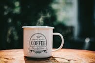 White Coffee Mug on Brown Surface
