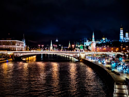 Free Beautiful nighttime cityscape of Moscow with illuminated Kremlin and reflections on the river. Stock Photo